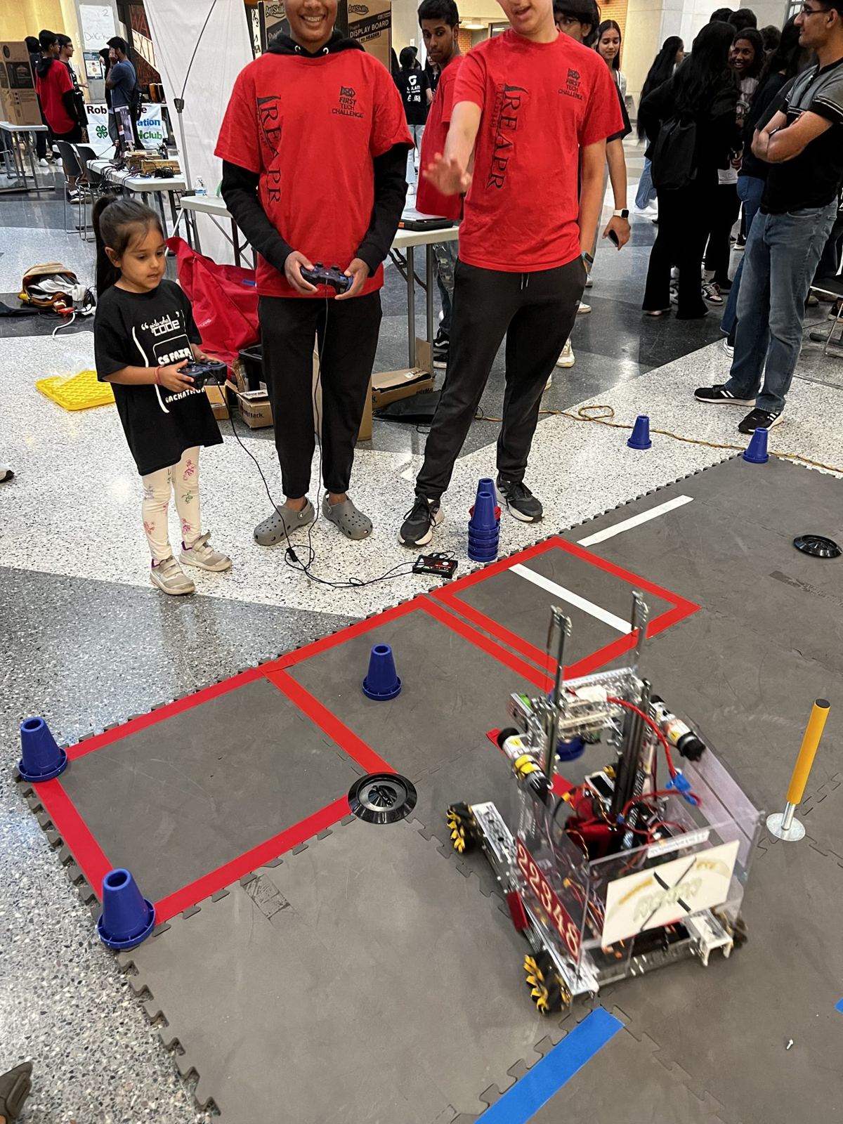 Students demonstrating a competition robot