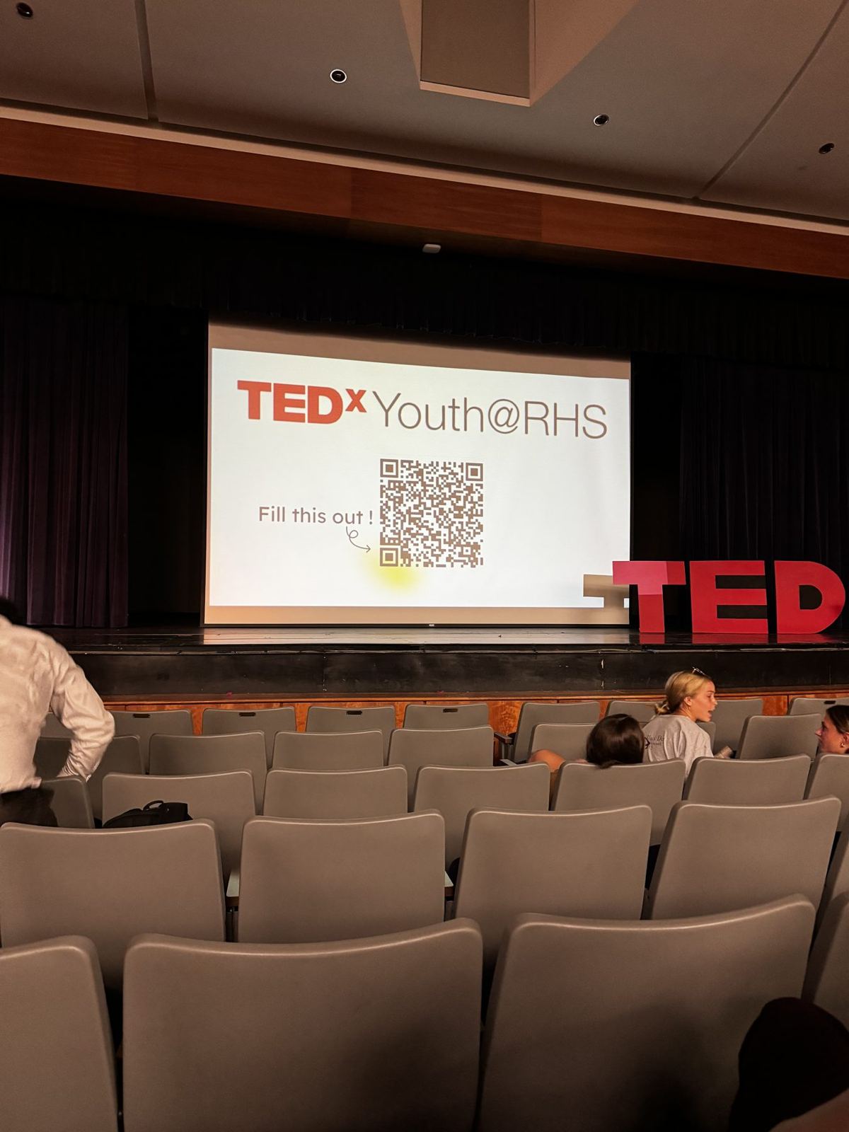 TEDxYouth@RHS title screen in the auditorium